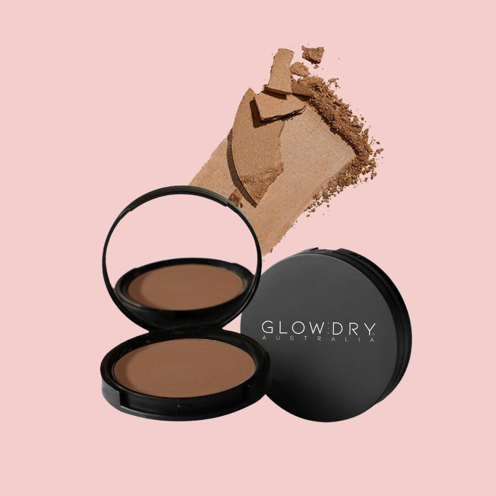 Compact mineral bronzing powder with a visible GlowDry brand logo on a pink background